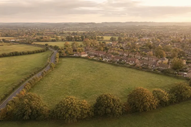 Aerial of a suburban edge where housing meets open countryside